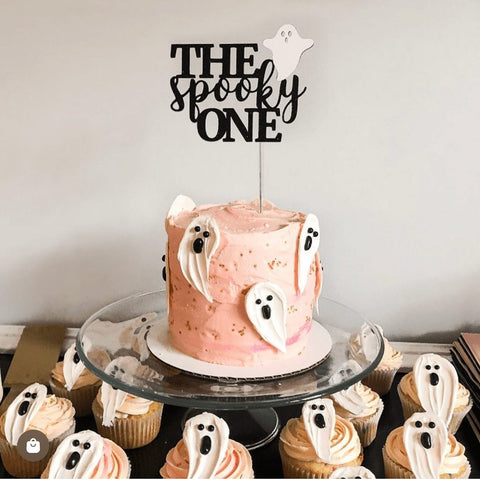 the spooky one cake topper on a pink ghost cake