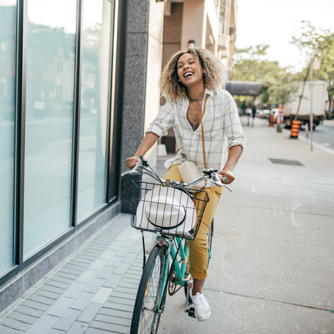 City bike hybrid bicycle woman riding in city biking