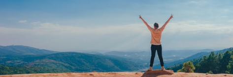 man on top of hill