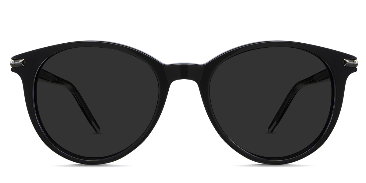 Sile black tinted sunglasses in cattle variant - it's a round frame with a slightly cat-eye look with a brushed metal style on the inside of the arm.