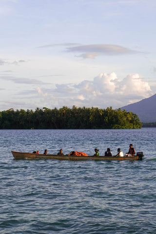 Munda locals pass Agnes Getaway in a boat