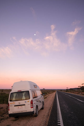 Campervan underneath the early morning moon