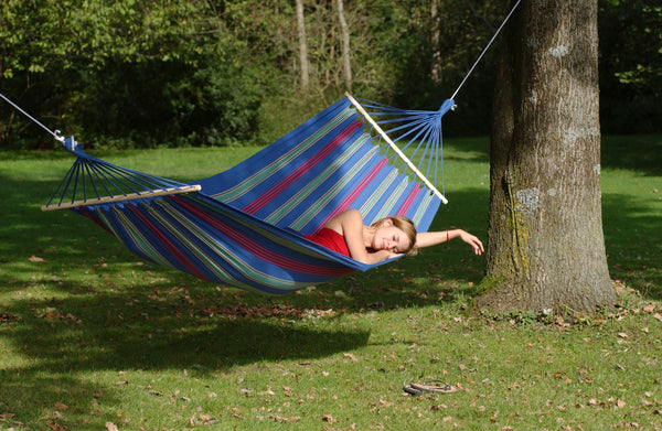 Woman sleeping in a spreader-bar hammock