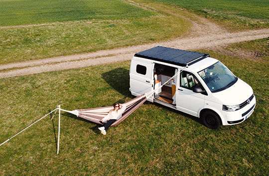 A Fabric Hammock and Stand attacked to a campervan