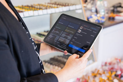 Woman on ipad using Shopify POS System