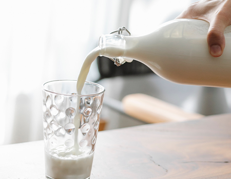 Pouring milk into a glass from a bottle