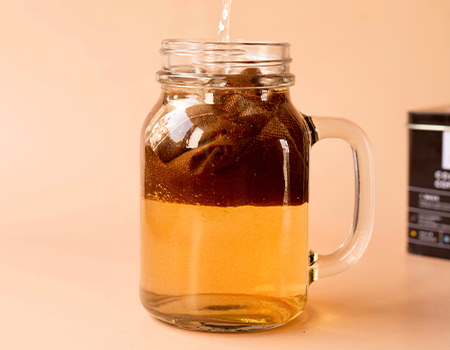 A jar with Rage Cold Brew coffee bag and water