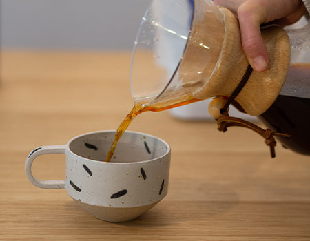 Serving freshly brewed pour over in a cup