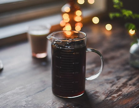 Pouring the filtered coffee in a tall glass