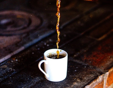 Adding filtered coffee to a cup