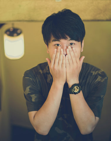 Man covering his mouth with both hands, for AutoBrush