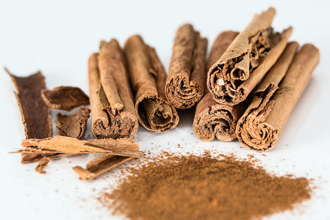 Cinnamon sticks and powder on a white background, for AutoBrush