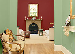 A living room area with a fireplace, with walls painted in a contrasting colour scheme.