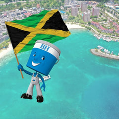 scenic image of Jamaica shoreline with BH Paints little blue man holding Jamaican flag
