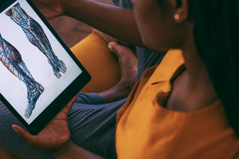 woman observing human body anatomy on tablet for CBD