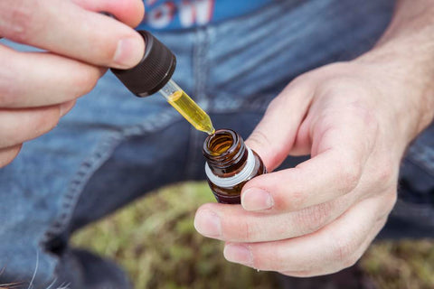 man taking hemp cbd oil sublingual tincture