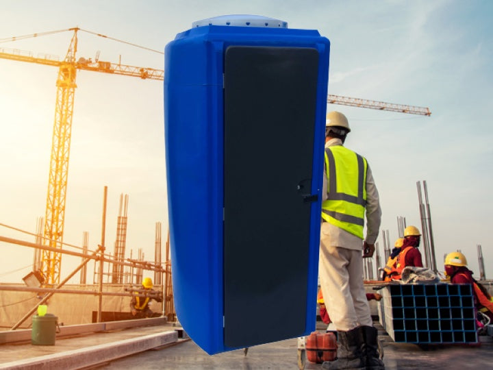 Consrtuction workers at a construction site with a blue Pioneer plastics MKII portable toilet in the foreground