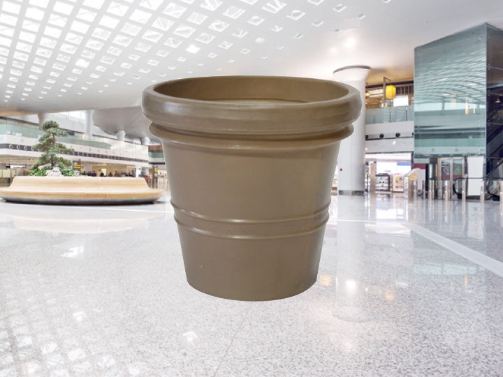 inside of a Shopping centre with a beige Pioneer plastics flower pot in the foreground