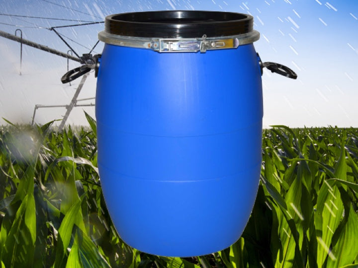 Farming field being watered witha blue Pioneer plastics Chemical drum in the foreground