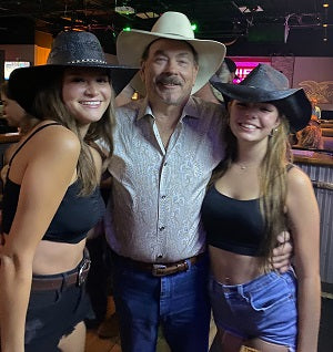 Robert and daughters in cowboy hats near me