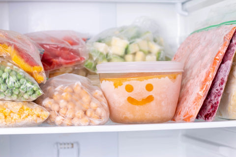 Containers of frozen vegtables in freezer