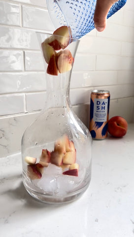 Pouring Peaches into Carafe