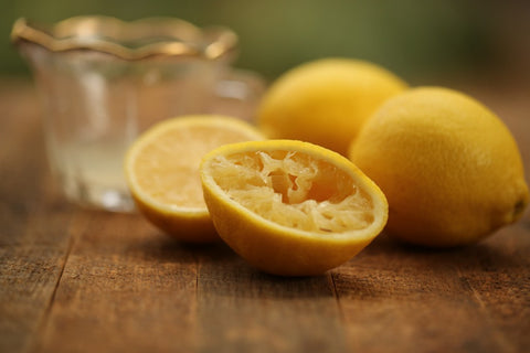 Squeezed lemon on wooden table