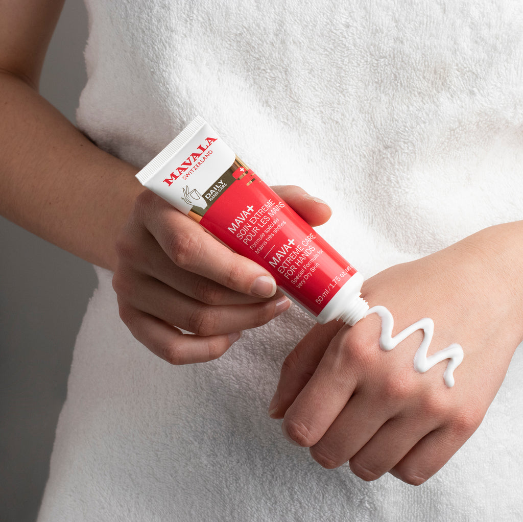 Woman applying Mava+ Extreme Hand Care on the back of her hand