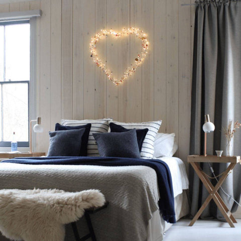 Boho heart wall light on a bedroom wall