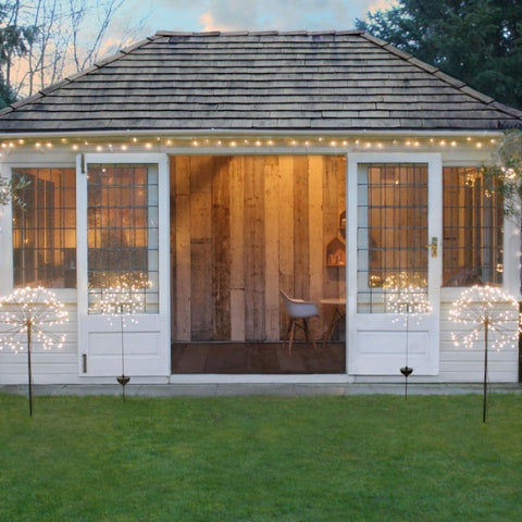 Silver cluster fairy lights on a summerhouse
