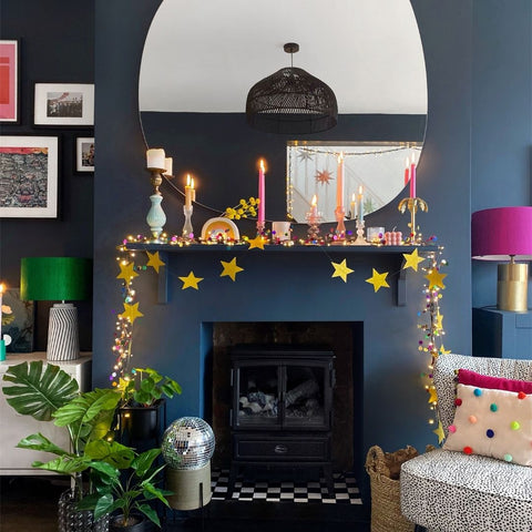 Confetti string lights along a mantlepiece in a colorful living room