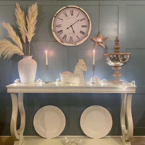 Copper starburst fairy lights along a console table