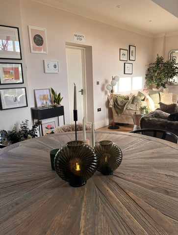 A round wooden table with Cordless Swirl Glass Table Lamps in a living room