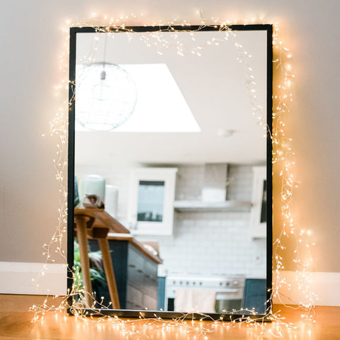 random twinkling cluster fairy lights around a mirror