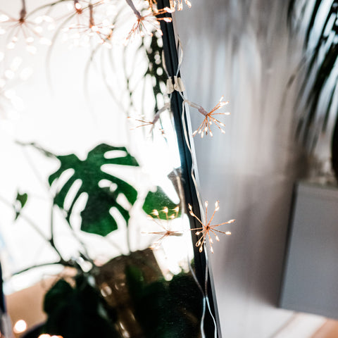 starburst copper fairy lights along the mirror