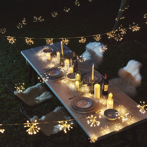 Outdoor garden fairy lights hanging over a table