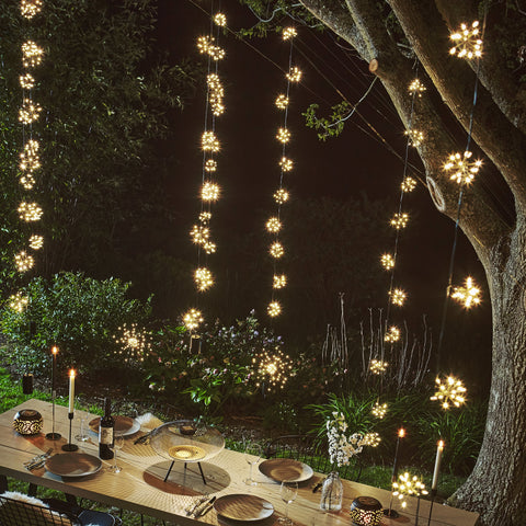 starburst fairy lights hanging on a tree