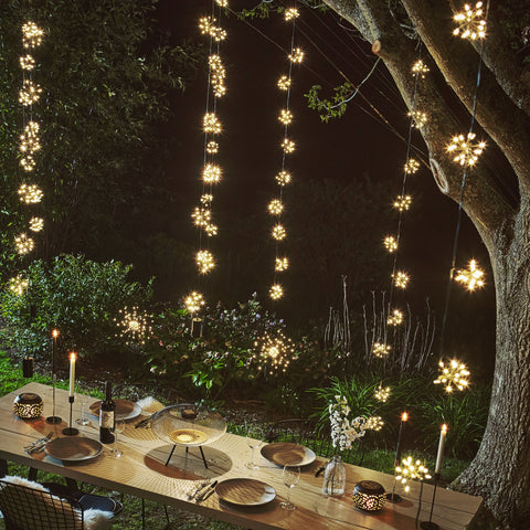 starburst fairy lights hanging on a tree