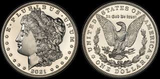 2021 Morgan Silver Dollar Obverse and Reverse. It shows the original designs of the morgan silver dollar, but has the date 2021. It is a stock photo with a black background.
