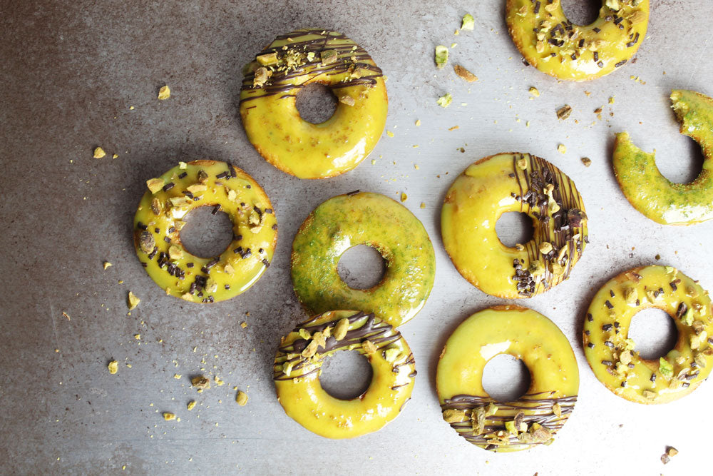 Pistachio Paste Donut with drizzled chocolate and chopped pistachios