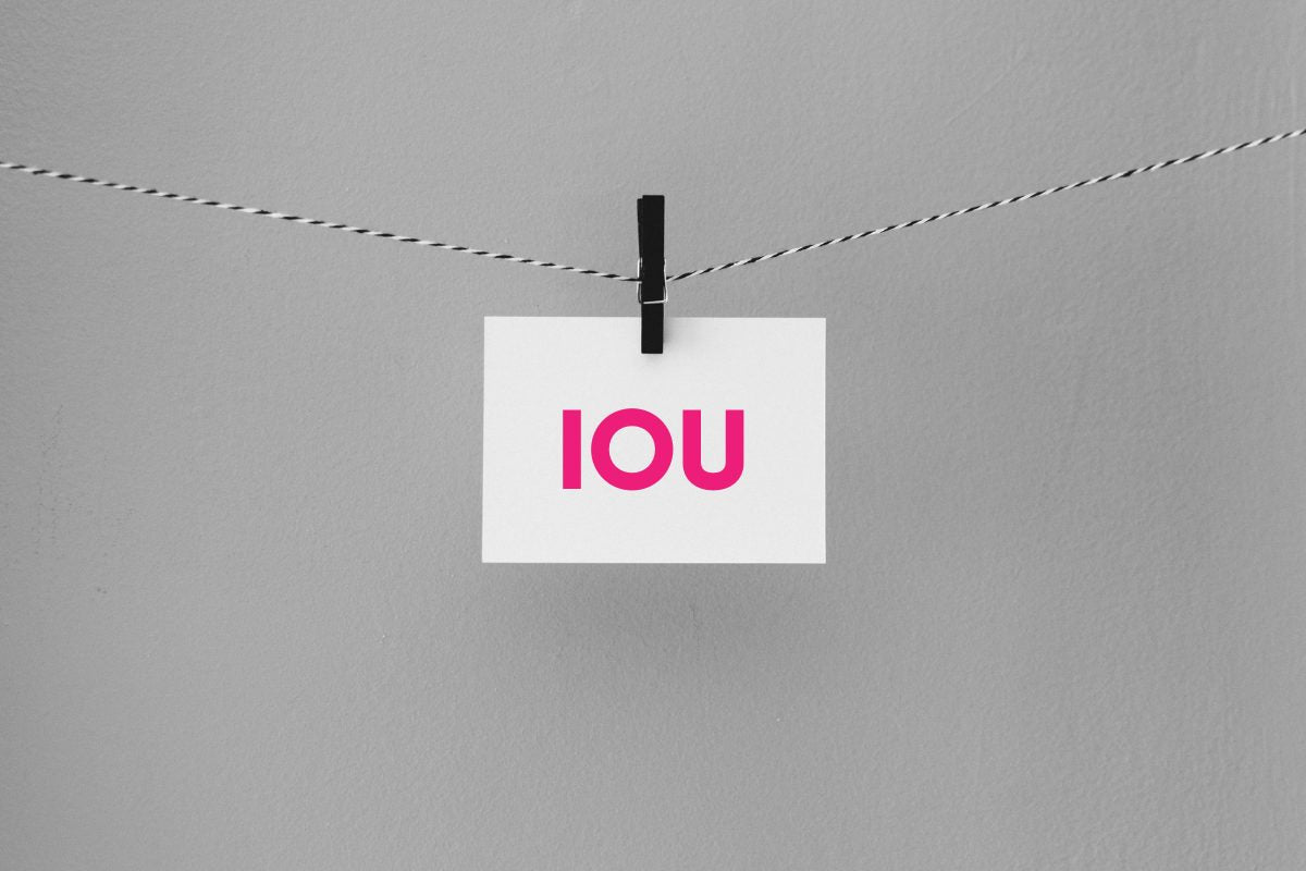 IOU Note Clipped to Line with Peg