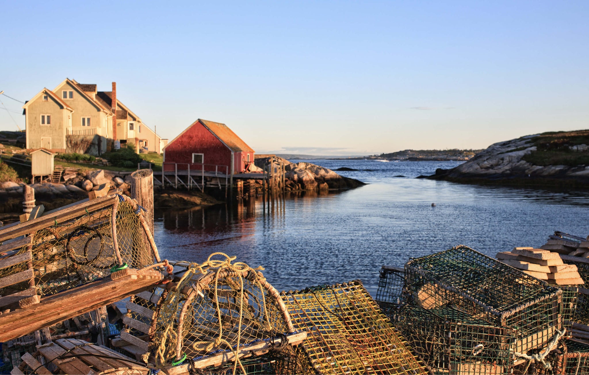Stunning ocean view with lobster traps under a soft blue sky