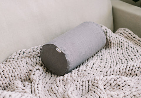 bolster pillow grey on couch with weighted blanket