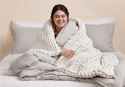 lady wrapped with white weighted blanket
