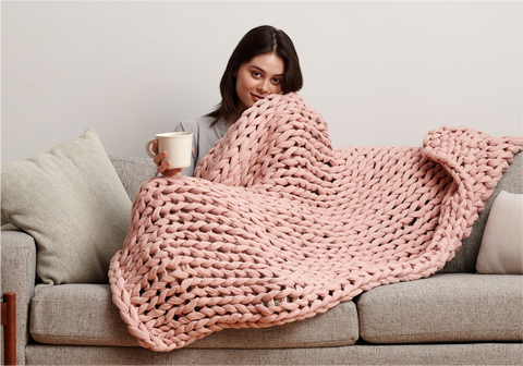 women wrapping with weighted blanket