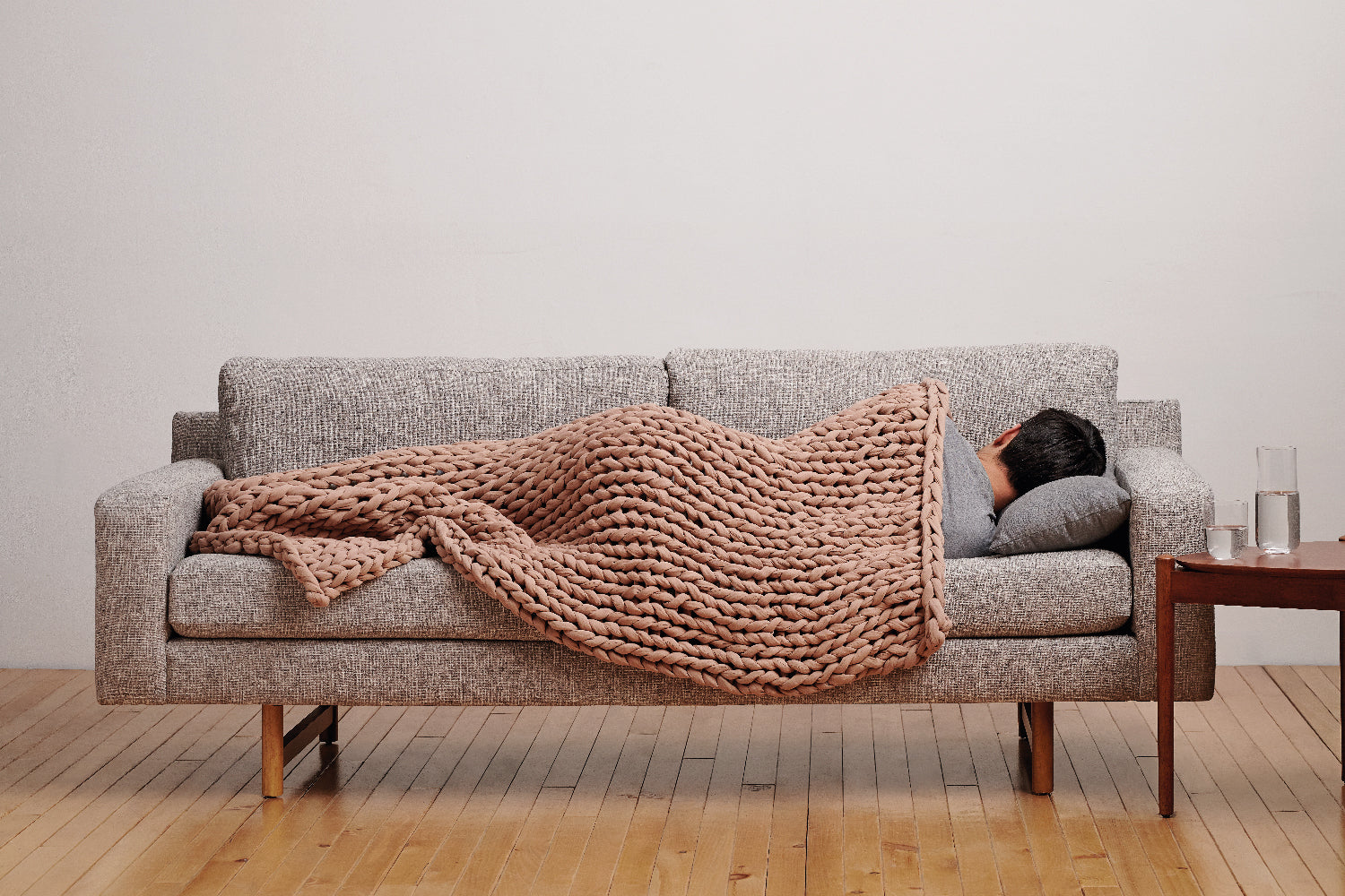 guy sleeping on side sofa weighted blanket