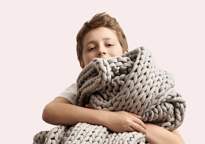 kid holding blanket