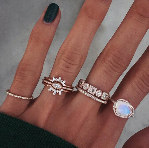 womans hand showing off several different diamond rings