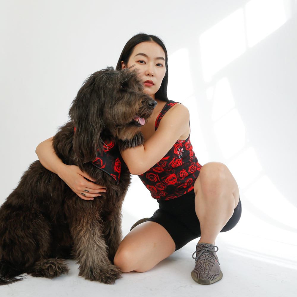 girl and her dog wearing matching rose bandana and tank top