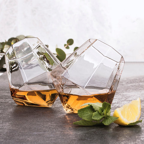 Pair of diamond shaped glasses filled with whiskey drink